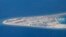 Chinese structures and an airstrip on the man-made Subi Reef at the Spratly group of islands in the South China Sea are seen from a Philippine Air Force C-130 transport plane of the Philippine Air Force, April 21, 2017. The South China Sea issue is expect