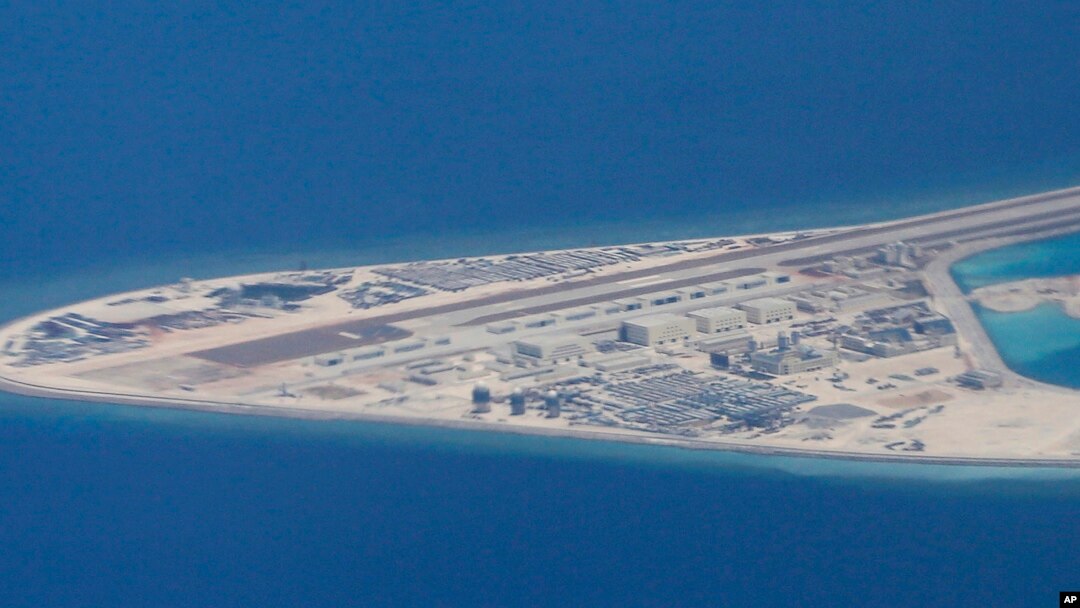 FILE - Chinese structures and an airstrip on the man-made Subi Reef at the Spratly group of islands in the South China Sea are seen from a Philippine Air Force C-130 transport plane of the Philippine Air Force, April 21, 2017.