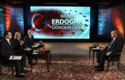 Turkey's President Recep Tayyip Erdogan, right, speaks during an interview with private A Haber and ATV television channels, in Istanbul, Dec. 15, 2019.