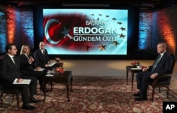 Turkey's President Recep Tayyip Erdogan, right, speaks during an interview with private A Haber and ATV television channels, in Istanbul, Dec. 15, 2019.