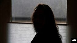 A former FBI analyst, who asked to be identified only as Becky, poses for a photo, Dec. 9, 2020, alleges misconduct by an FBI supervisory special agent at a colleague’s farewell party in 2017.