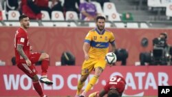 FILE - Bayern's Lucas Hernandez, left, is challenged by Tigres' Andre Gignac during the Club World Cup final soccer match between FC Bayern Munich and Tigres at the Education City stadium in Al Rayyan, Qatar, Feb. 11, 2021. 