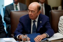 FILE - US Commerce Secretary Wilbur Ross listens during a Cabinet meeting in the Cabinet Room of the White House, July 16, 2019, in Washington.