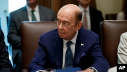 FILE - US Commerce Secretary Wilbur Ross listens during a Cabinet meeting in the Cabinet Room of the White House, July 16, 2019, in Washington.