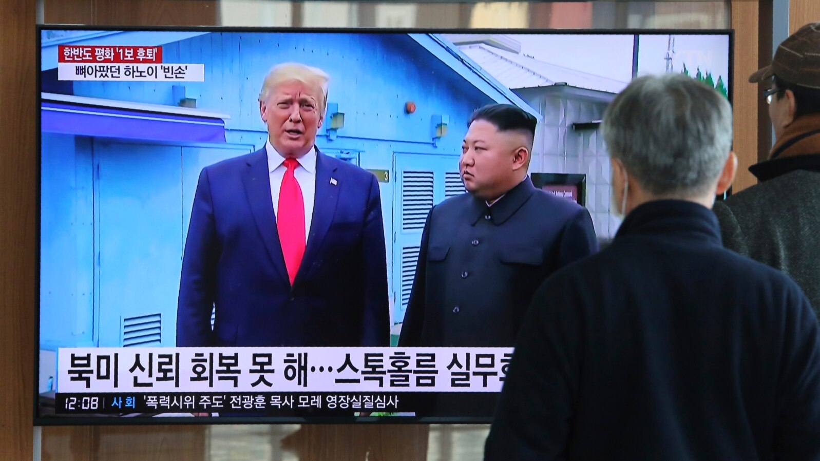 FILE - People watch a TV screen showing a file image of North Korean leader Kim Jong Un and U.S. President Donald Trump, left, during a news program at the Seoul Railway Station in Seoul, South Korea, Dec. 31, 2019.