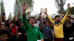 Kashmiri men shout slogans during a protest against the alleged rape of a 3 year old girl from north Kashmir at Mirgund, outskirts of Srinagar, Indian controlled Kashmir, May 13, 2019. 