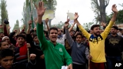 Kashmiri men shout slogans during a protest against the alleged rape of a 3 year old girl from north Kashmir at Mirgund, outskirts of Srinagar, Indian controlled Kashmir, May 13, 2019. 