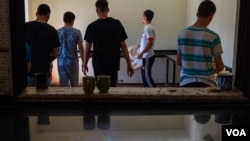 Teenagers kept in al-Houri Rehabilitation Center prepare the food that will be served for lunch for the 100 inmates Northeast Syria, on October 9, 2024. (Yan Boechat/VOA)