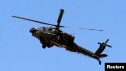 An Egyptian military helicopter is seen deployed in the northeastern part of the Sinai Peninsula near the Rafah border crossing between Egypt and the Gaza Strip in this May 21, 2013, file photo.