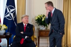 FILE - White House chief of staff Mick Mulvaney talks with US President Donald after his meeting with NATO Secretary General Jens Stoltenberg at Winfield House, Dec. 3, 2019, in London.