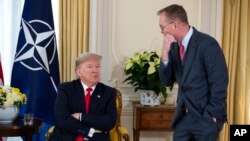 White House chief of staff Mick Mulvaney talks with US President Donald after his meeting with NATO Secretary General Jens Stoltenberg at Winfield House, Dec. 3, 2019, in London. 