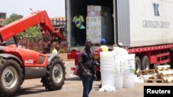 Workers from Doctors Without Borders unload emergency medical supplies to deal with an Ebola outbreak in Conakry, Guinea, March 23, 2014. 