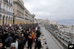 FILE— Algerians demonstrate in the streets of Algiers, April 16, 2021. A crowd of protesters marched in the streets of Algeria capital Algiers in support for the Hirak pro-democracy movement.