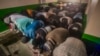 FILE — Imam Omar Niass, third from left top, lead evening prayers for African migrants, before the breaking of Ramadan fast and the serving of a festive meal called an iftar, Friday March 15, 2024, at Bronx's Masjid Ansaru-Deen mosque in New York. 