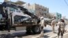 Iraqi security forces stand guard at the site of a bomb attack in Baghdad's northern Shaab Shi'ite district, Iraq, May 30, 2016.