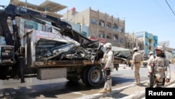 Iraqi security forces stand guard at the site of a bomb attack in Baghdad's northern Shaab Shi'ite district, Iraq, May 30, 2016.