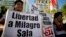 A woman holds a banner that reads in Spanish "Free Milagro Sala" during a demonstration in support of Argentina's Tupac Amaru social movement leader Milagro Sala, in Buenos Aires, Argentina, Jan. 27, 2016.