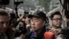FILE - Outspoken media tycoon Jimmy Lai talks to the media after walking out of the Wanchai police station in Hong Kong, Jan. 21, 2015.