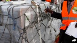 Independent Electoral and Boundaries Commission IEBC officials receive ballot papers for the repeat of the presidential election on Oct. 26, at JKIA airport in Nairobi, Kenya, Oct. 23, 2017.