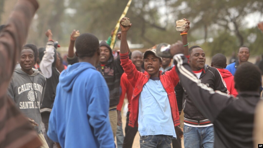 FILE - Protesters clash with Zimbabwean police in Harare, July, 4, 2016. 