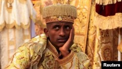 FILE - An Ethiopian Orthodox Deacon waits to perform during the Meskel festival celebration to commemorate the discovery of the True Cross on which Jesus Christ was crucified, in Addis Ababa, Ethiopia, September 27, 2023.