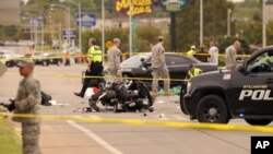 A damaged police motorcycle rests in the intersection after a vehicle crashed into a crowd of spectators during the Oklahoma State University homecoming parade, causing multiple injuries, on Saturday, Oct. 24, 2015 in Stillwater, Oklahoma.