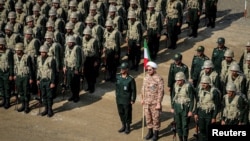 FILE - Members of the Islamic Revolutionary Guard Corps (IRGC) attend an IRGC ground forces military drill in East Azerbaijan province, Iran, Oct. 17, 2022. 