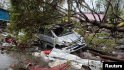 A car damaged by a tree is seen after the passing of Hurricane Iota in Puerto Cabezas, Nicaragua, Nov. 17, 2020.