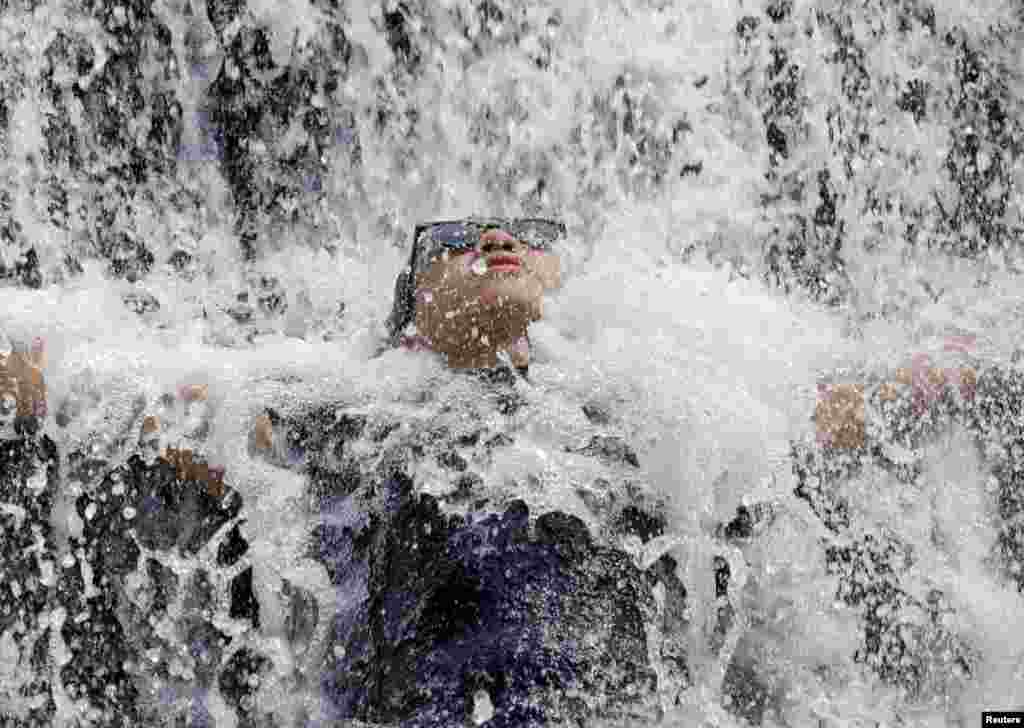 A man cools off in splashing water at Wawa Dam in Rodriguez, Rizal province, Philippines.