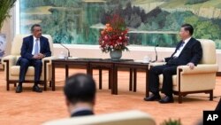 Tedros Adhanom, director general of the World Health Organization, left, meets with Chinese President Xi Jinping before a meeting at the Great Hall of the People in Beijing, Tuesday, Jan. 28, 2020. (Naohiko Hatta/Pool Photo via AP)