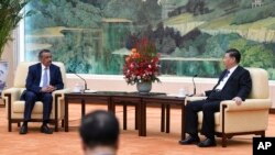 Tedros Adhanom, director general of the World Health Organization, left, meets with Chinese President Xi Jinping before a meeting at the Great Hall of the People in Beijing, Tuesday, Jan. 28, 2020. (Naohiko Hatta/Pool Photo via AP)