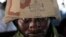 A soldier looks out from under the brim of his helmet in Maiduguri, Nigeria, June 6, 2013.