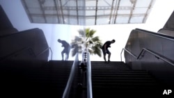 A man looks down a stairway at a shuttered Metro station in Athens, as Metro workers are on 24 -hour strike to protest staff and material shortages, on May 14, 2018. 