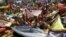 Hindu devotees hold up scarves to receive rice as offerings being distributed by the temple authority on the occasion of the Annakut festival in Kolkata, India.