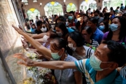 Filipino Catholics pray with protective masks on following confirmed cases of coronavirus in the country, at the National Shrine of Our Mother of Perpetual Help, Paranaque City, Metro Manila, Philippines, Feb. 5, 2020.