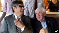 Chen Guangcheng, left, who became an American citizen, laughs with one of his attorneys, George Bruno, July 8, 2021, during a lunch to celebrate his citizenship in Manchester, New Hampshire.