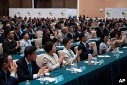 Election committee members celebrate after Sam Hou Fai is declared the new chief executive after an election in Macao, Oct. 13, 2024.