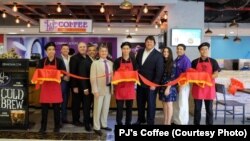 Employees and officials with PJ's Coffee of New Orleans at the ribbon-cutting ceremony last month for the company's first coffee shop in Vietnam.