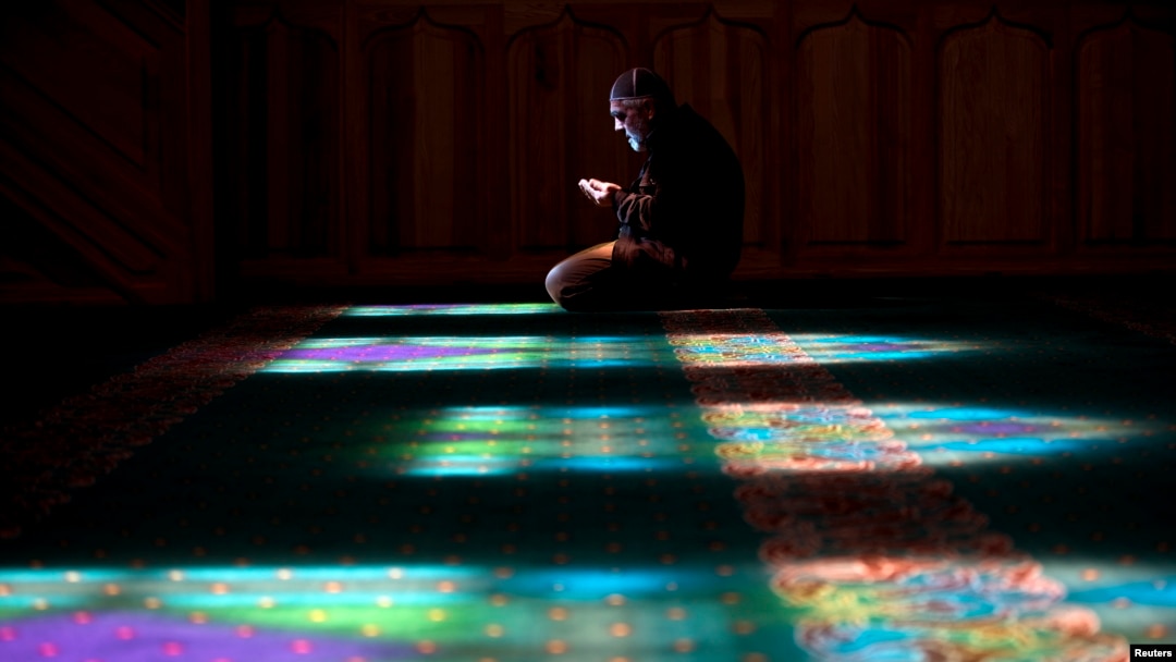 A Crimean Tatar man prays at a mosque in Bakhchysarai, Ukraine, March 10, 2014.
