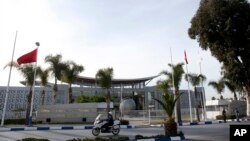 A police officer rides in front of the International Conference Center where the signing of a U.N.-sponsored deal aiming to end Libya's conflict was to take place in Sikhrat, Morocco, Dec.16, 2015. The deal is expected to be signed Thursday. 