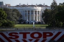 The White House is seen behind a vehicle barrier, in Washington, June 7, 2020, the morning after massive protests over the death of George Floyd were held in the U.S. capital.