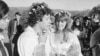 Arlo Guthrie sings 'Amazing Grace' to his new bride, Jackie Hyde, at their wedding ceremony on Guthrie's Washington, Mass., farm on Oct. 9, 1969. Alice Brock of 'Alice's Restaurant' is second from the right in the background.