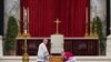 FILE: Archbishop Georg Gaenswein kisses the Bible on top of former Pope Benedict's coffin during his funeral, in St. Peter's Square at the Vatican, January 5, 2023. 