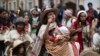 A woman marches with her children in an anti-government demonstration in Bogota, Colombia.