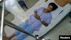 FILE - San Petchrod, 47, lies in bed where he is being treated for malaria at Sai Yoke hospital, Kanchanaburi Province, Thailand, Oct. 26,2012. 