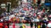 Thousands of teachers and supporters hold signs in the rain during a rally, Jan. 14, 2019, in Los Angeles. Tens of thousands of Los Angeles teachers went on strike Monday for the first time in three decades after contract negotiations failed.