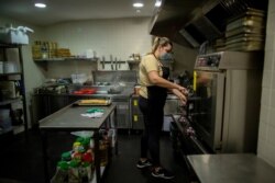 Rocio Sanchez works in the kitchen at La Francachela restaurant in Madrid, Spain, March 26, 2021.