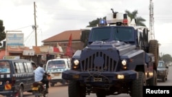 FILE - Riot police patrol the streets in Kampala, Uganda.