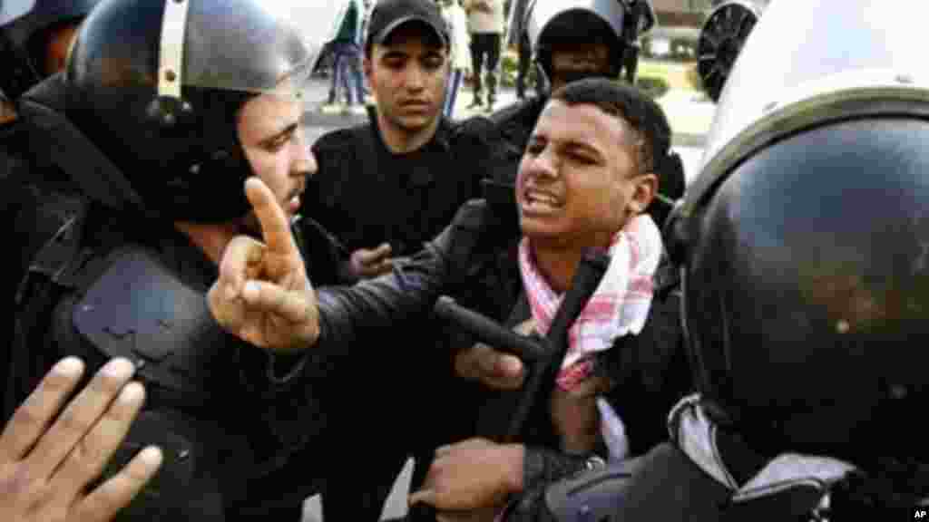 Egyptian riot police detain a man during clashes with supporters of ousted President Mohamed Morsi Cairo, Egypt, January 10, 2014.