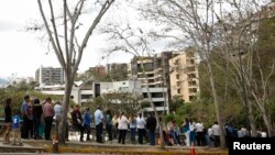 People, many of whom are seeking visas, form a line outside the U.S. Embassy in Caracas, March 4, 2015.